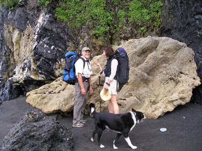 Paul Morgan Leslie Warren and Cole the dog by a travertine boulder