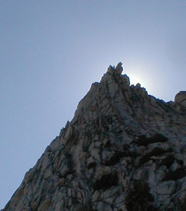 person backlit on the summit of Cathedral